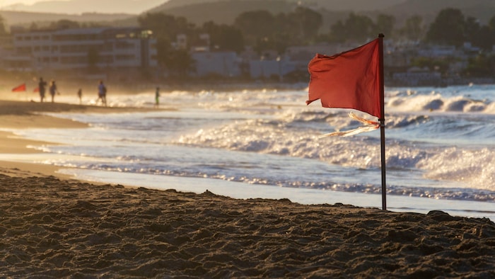 Bei einer roten Flagge am Strand gilt absolutes Badeverbot – mit gelber Flagge mahnen Behörden ...