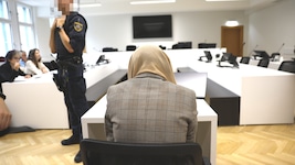 Die 30-Jährige verdeckt vor Gericht in Wien ihr Gesicht mit einem Tuch.