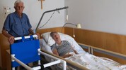 Manfred und Brigitte V. mit dem Gehstuhl, der zur Mobilisierung der Frau benötigt wird