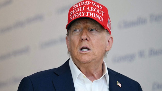 "Trump was right about everything," reads the US president's hat.