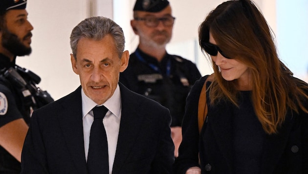 Sarkozy with his wife Carla Bruni before the verdict was announced
