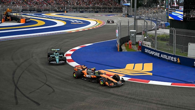 Fernando Alonso (left) set the fastest time in the first Singapore practice session.
