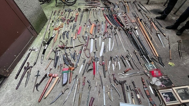 An entire arsenal of weapons and Nazi devotional objects with swastikas were found in the ...