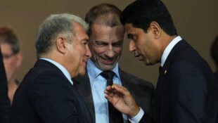 UEFA-Präsident Aleksander Ceferin (Mitte), Barcelona-Boss Joan Laporta und PSG-Präsident Nasser ...
