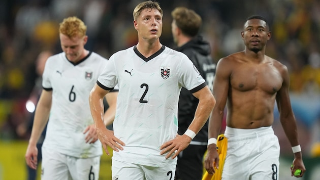 The disappointment is written all over the faces of Austria's team players after the last-minute ...