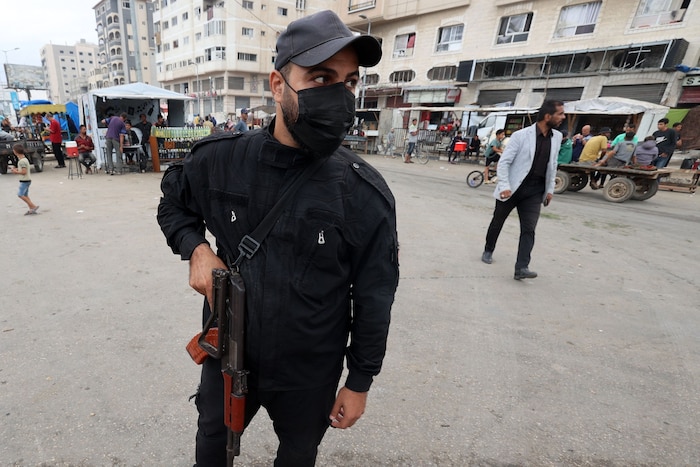 An armed fighter at a checkpoint in the settlement of Nuseirat in central Gaza