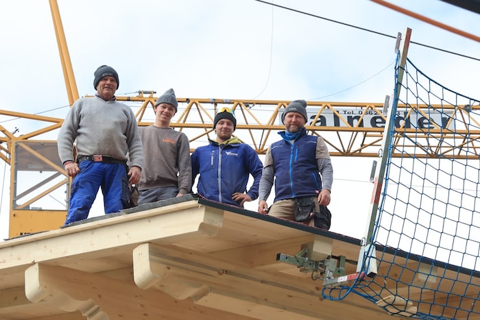 Workers from the local carpentry workshop are working on the roof.