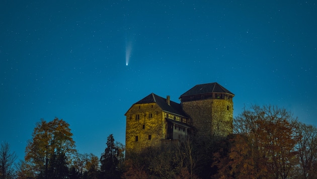 Farbenfroher Komet: Der Kopf schimmert grünlich, dahinter leuchtet der Schweifstern gelblich, ...