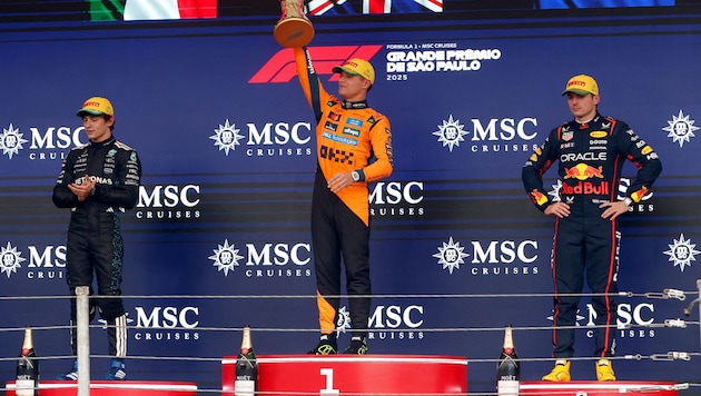 Lando Norris (center) was also booed in Brazil.