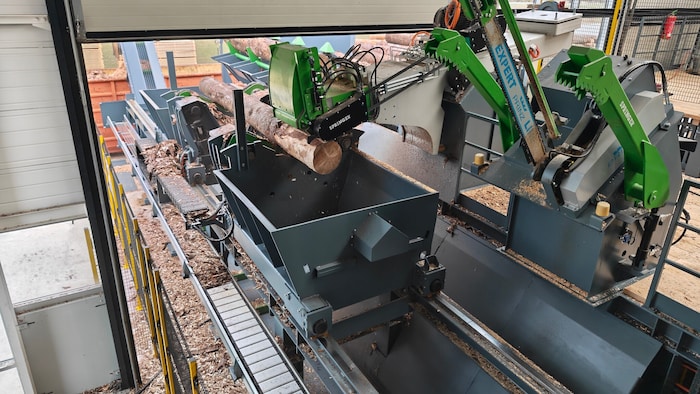 Ein Roboter entrindet das Rundholz, bevor es in die Box kommt.