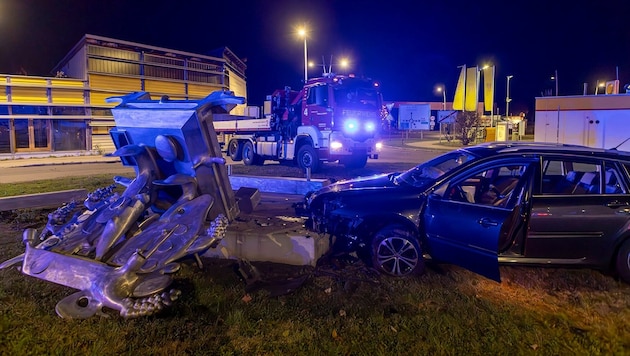 The car drove directly into the sculpture on the traffic circle.