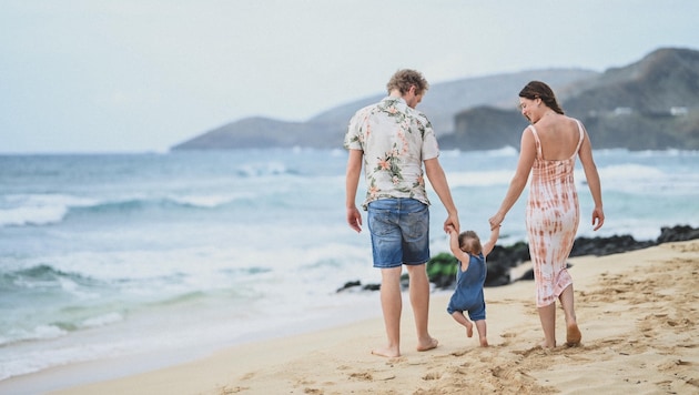 Die junge Familie am Strand in Hawaii.
