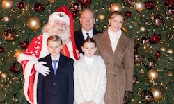 Die Fürstenfamilie posiert mit dem Weihnachtsmann vor dem beleuchteten Weihnachtsbaum.