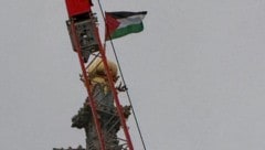 Per Kran mussten die beiden Palästina-Flaggen von den Türmen der Votivkirche entfernt werden. ...