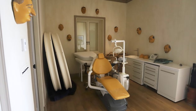 Masken an den Wänden machen das „Behandlungszimmer“ noch schauriger.