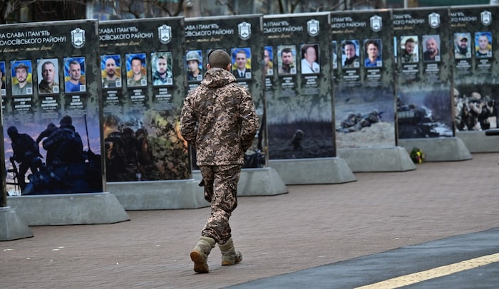 Ein Soldat läuft an Gedenktafeln in Kiew vorbei.