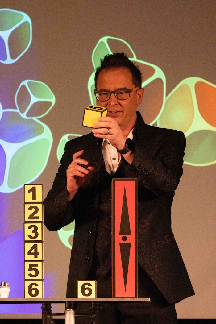 Pfarrer Smetanig während eines Auftritts als „The Magic Priest“ auf einer Bühne vor Publikum.