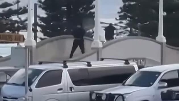 This photo shows the two assassins dressed in black on a bridge, from where they are shooting at ...