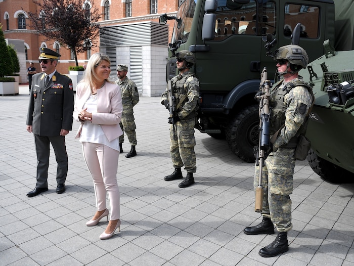 Hameseder (left) advises Minister Tanner.