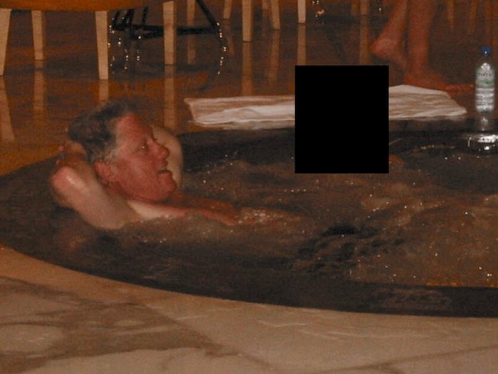 Bill Clinton in a hot tub at an unknown location with an unrecognizable person.