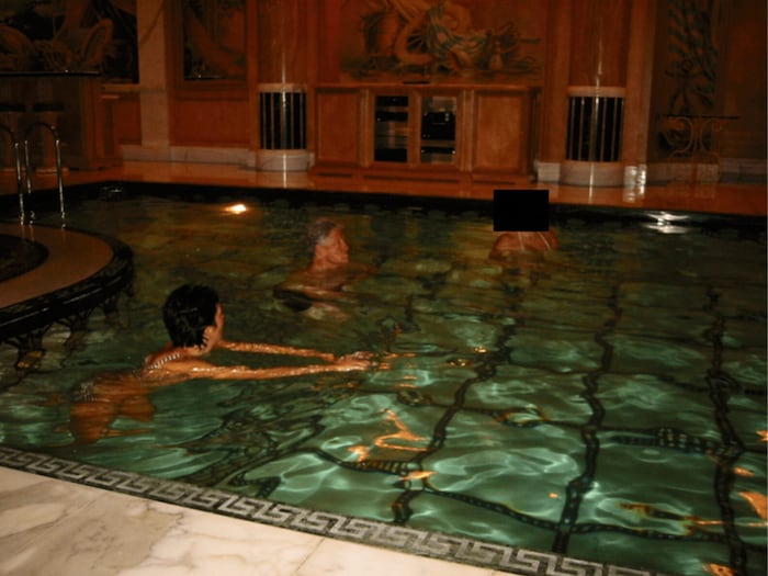 Ghislaine Maxwell and former President Bill Clinton swimming with an unknown third person.