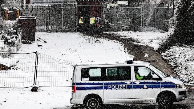 The police are on duty at the cable bridge where a fire is said to have triggered the blackout.