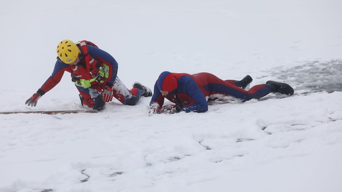 Helfer und Opfer bleiben nahe am Boden, bis das rettende Ufer erreicht ist, um nicht gleich ...