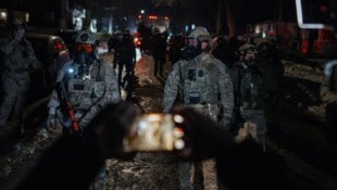Ein Demonstrant in Minneapolis richtet während eines Protests sein Handy auf Beamte der ...