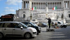 Eine Polizistin regelt den Verkehr am Piazza Venezia in Rom.