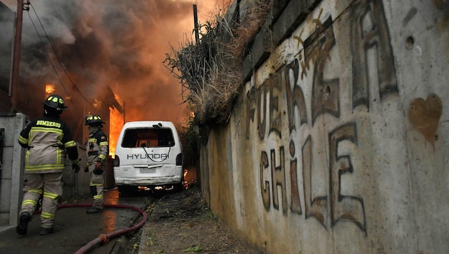 Die Feuerwehr unternimmt alles in ihrer Macht stehende, um der Flammen in Concepción Herr zu ...