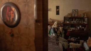 Eine ältere Frau muss nach russischen Angriffen auf die Energieinfrastruktur in ihrer Wohnung ...