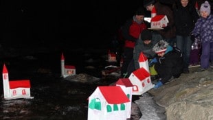 Die Kinder von Eisenkappel übergeben ihre sorgfältig gebastelten Kirchlein heute der Vellach.
