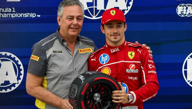 Mario Isola (left, next to Ferrari driver Charles Leclerc)