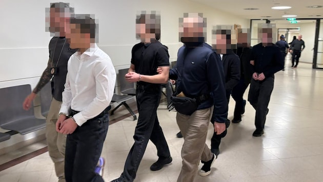 The four defendants in custody are facing serious charges.