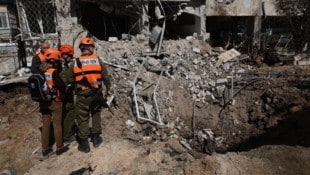 Rettungskräfte versammeln sich am Dienstag am Ort eines iranischen Raketenangriffs in Tel Aviv.