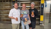 V.l.n.r. Pietschnigg mit Eggeler und Jury. Teil des Erlöses der Brezel geht an die Schule.