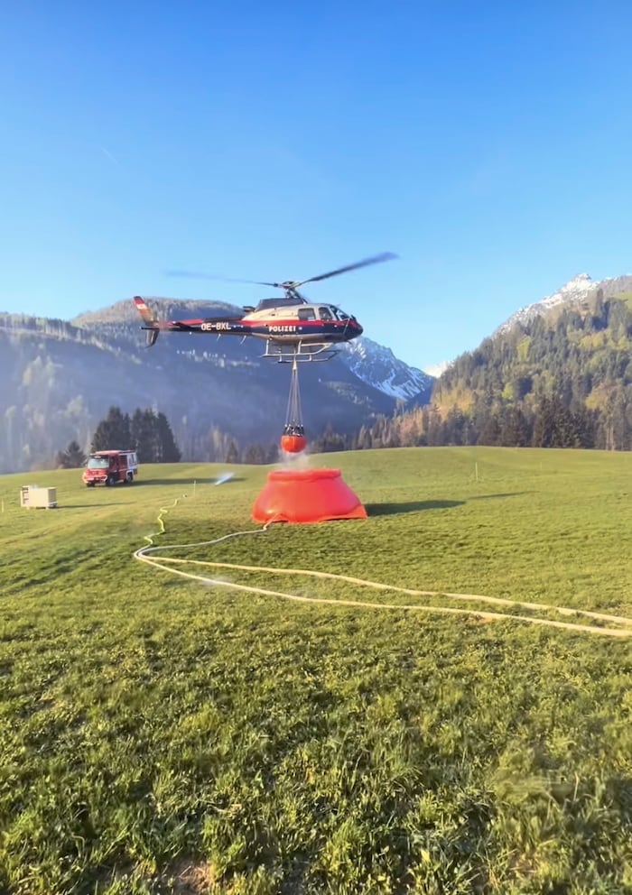 Three police helicopters are extinguishing the fire from the air.