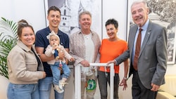 Bürgermeister Klaus Schneeberger (re.) übergab das Fenster samt buntem Fisch an Familie Tremmel.