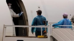 Temperaturscans vor dem Besteigen eines Passagierflugzeuges, welches Menschen vom ...