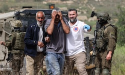 Palästinensische Sanitäter helfen einem Mann, der von israelischen Siedlern mit Pfefferspray ...