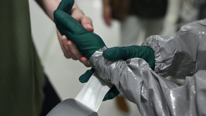 Zwei Paar Handschuhe werden übereinander getragen.