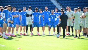 Teamchef Ghalenoei (in Schwarz) stimmt das iranische Team auf das Spiel gegen Ägypten ein.