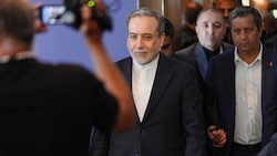 Der iranische Außenminister Abbas Araqchi (m.) ist Teil der Delegation. 