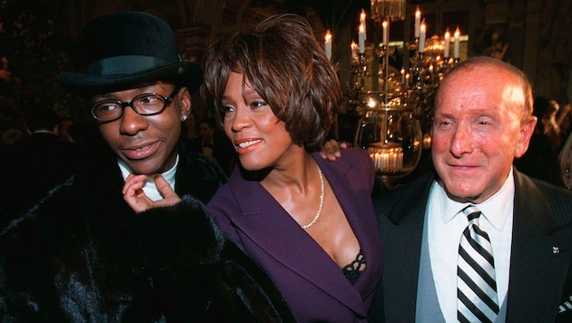 Bobby Brown (links) und Whitney Houston erscheinen 1998 zusammen mit dem Musikproduzenten Clive ...