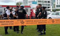 Die Polizei versammelte sich zu einer Besprechung in der Nähe des Tatorts. Zerbrochene Fenster ...