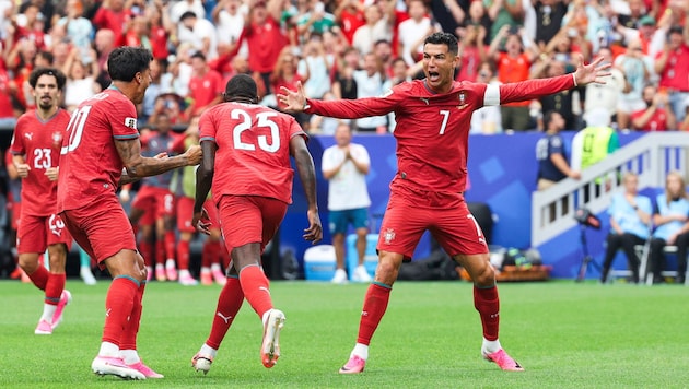 Cristiano Ronaldo (right) and his teammates celebrate a lopsided victory over Uzbekistan.