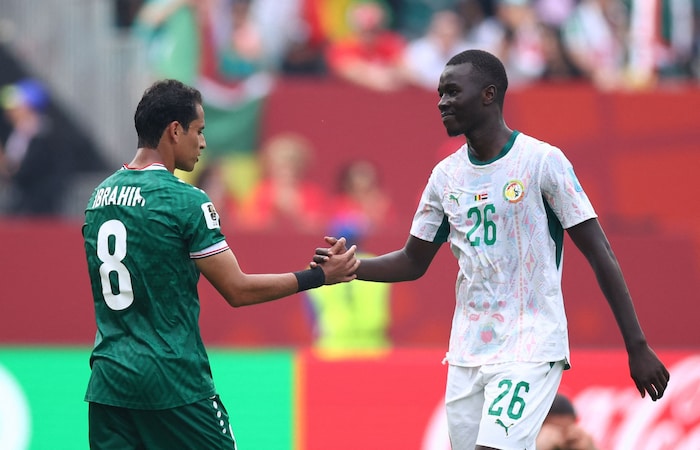 Post-match handshake: Iraq’s Ibrahim Bayesh (left) and Senegal’s Pape Gueye.