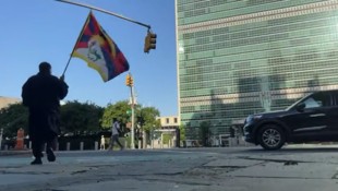Aktivist Loga Rangzen mit einer tibetischen Flagge vor dem UNO-Hauptquartier in New York – kurz ...