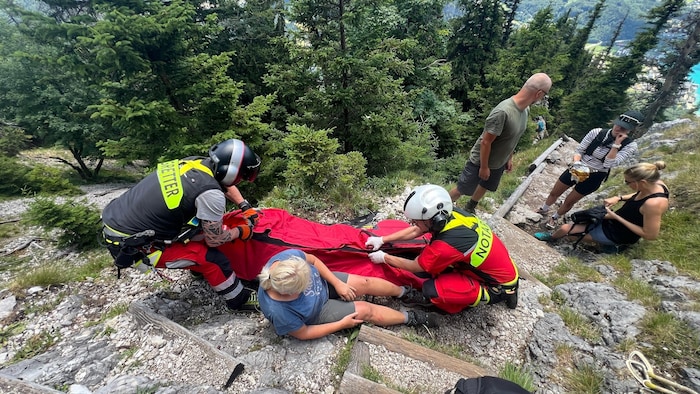 Rescuers airlifted the injured woman off the mountain in a rescue helicopter.