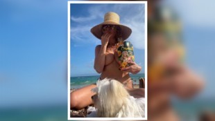 Andere packen Sonnencreme ein, Heidi packt ihre Chips aus: Die Model-Queen gönnt sich am Strand ...